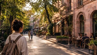 Quiet morning street in Yerevan with cafés, pink stone buildings and people walking slowly