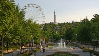 Warm evening view of Victory Park in Yerevan with walking people, fountains and green park atmosphere
