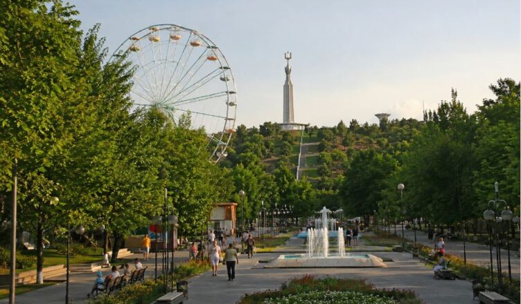 Warm evening view of Victory Park in Yerevan with walking people, fountains and green park atmosphere